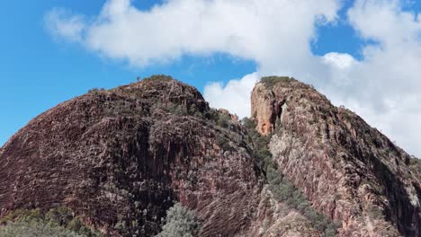 time-lapse of clouds moving above split rock’s rugged peak in warrumbungle national park, australia, under bright daylight with a steady wide shot