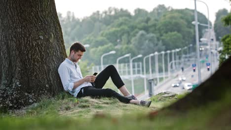 a young man using a mobile outdoors