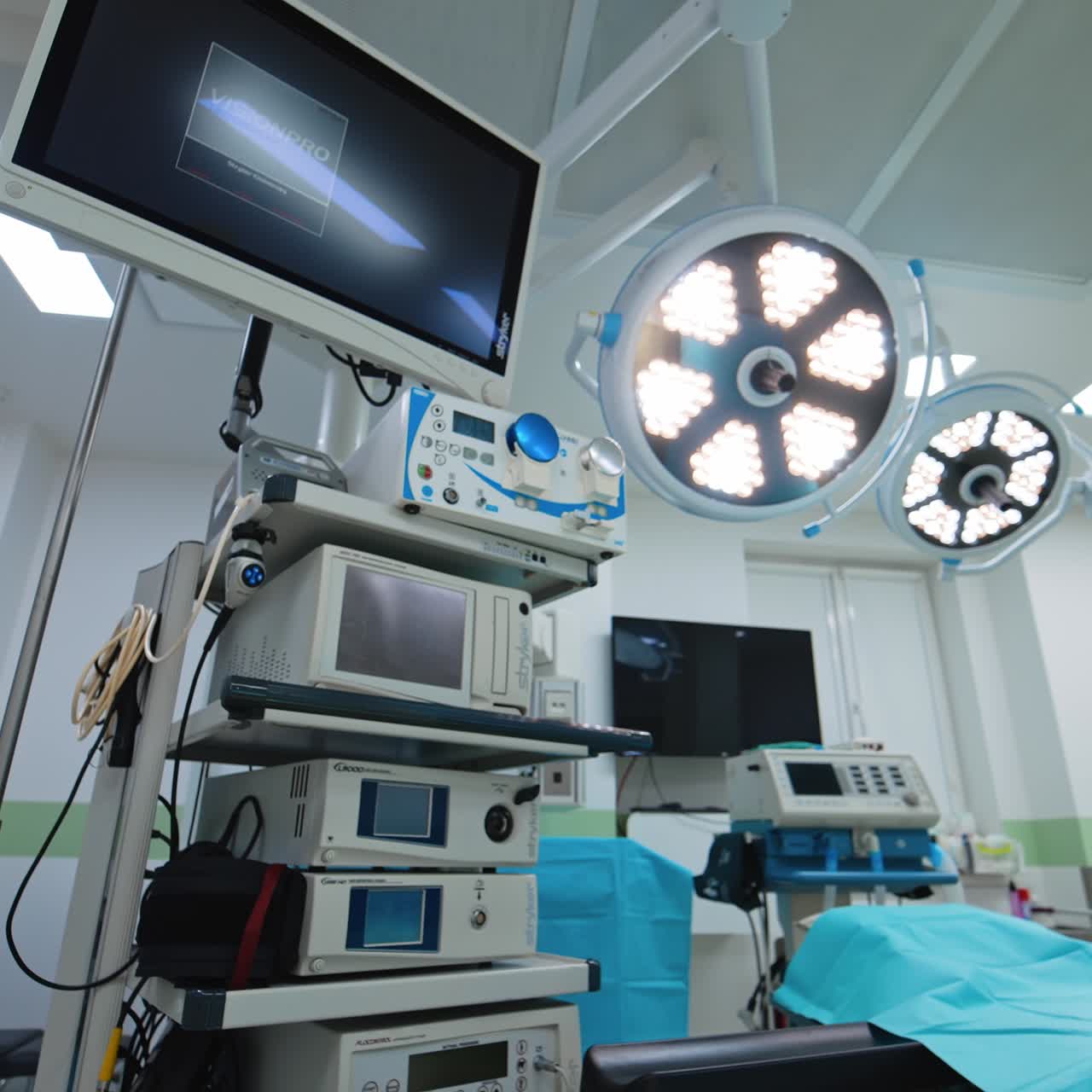 Advanced medical equipment in the bright light of lamps on the ceiling of surgery room. Low angle view of the operational room for neurosurgery