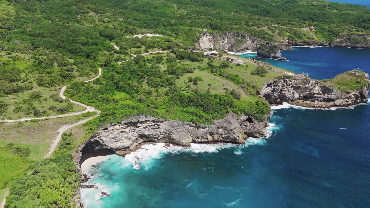 Aerial View Manta Bay on Nusa Penida showcasing rugged coastline and crystal clear waters of Bali, Indonesia