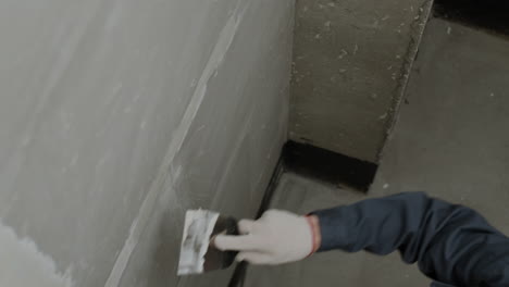 construction worker repairing a wall