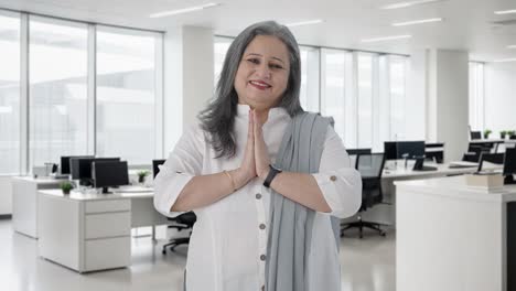 Happy-Indian-senior-businesswoman-greeting-and-doing-Namaste