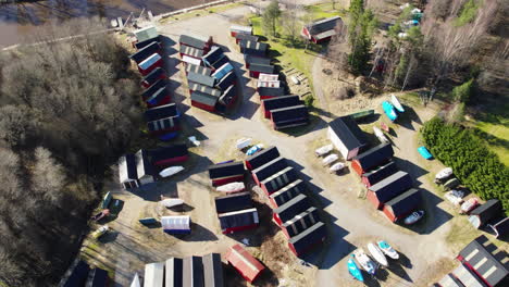 orbit aerial red fishing cabins near coast, scandinavia