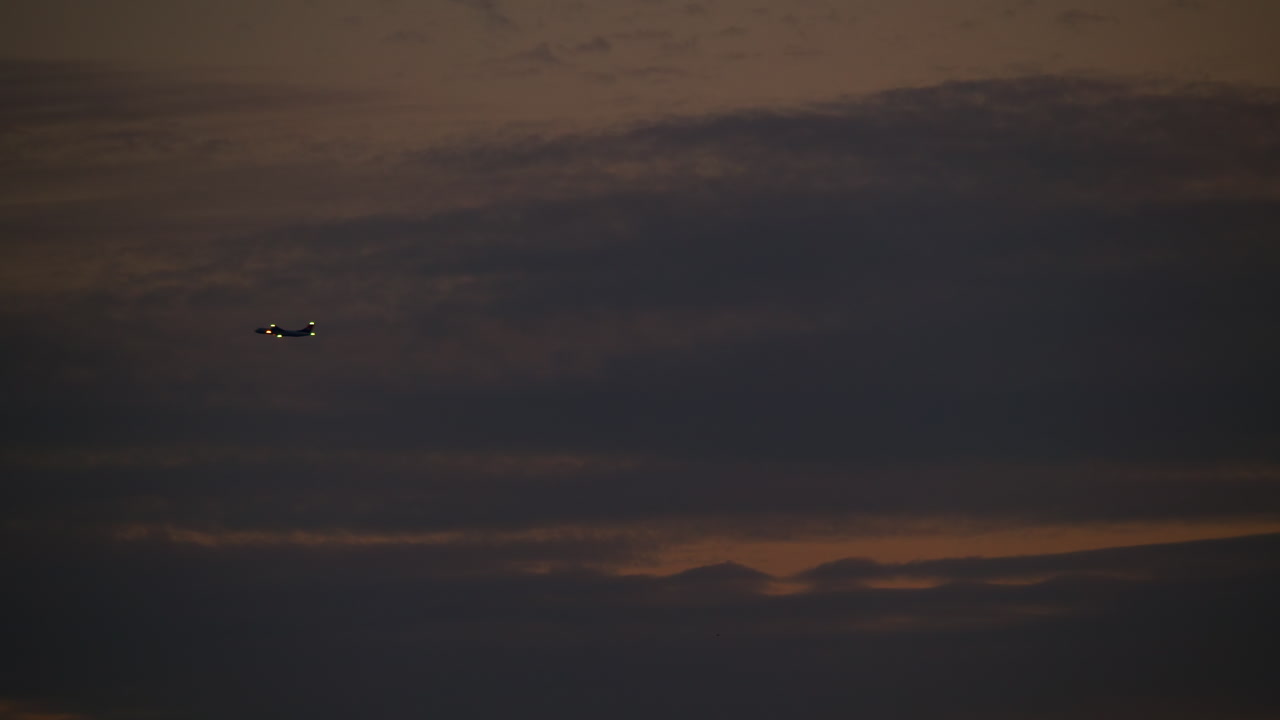 Airplane Flying at Sunset