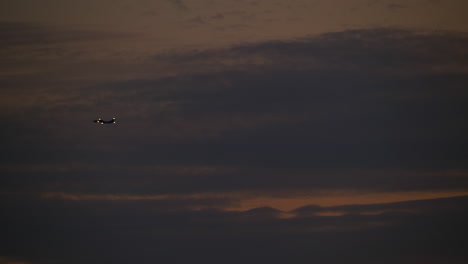 airplane flying at sunset