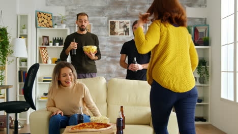 young woman arriving with pizza to watch a football match