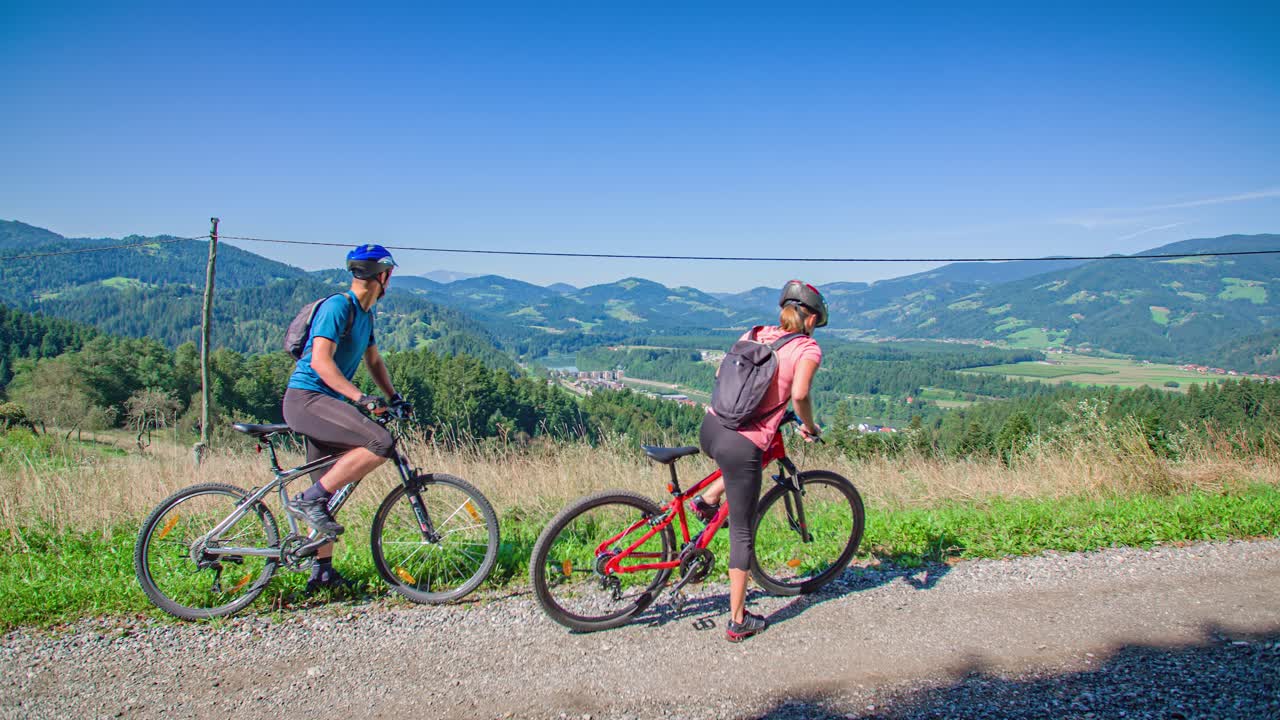 Couple starts their mountain bike adventure through nature. Stunning Slovenian landscape