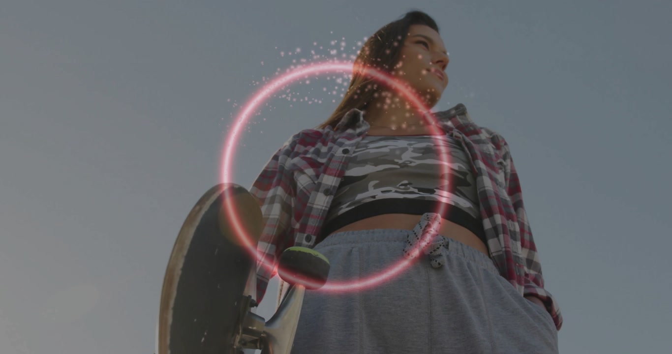 Woman holding skateboard under sky initiating neon ring glowing and sparkles swirling for sports ad