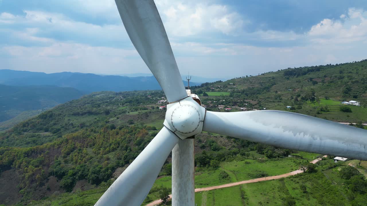 Aerial view of wind turbine in rural Honduras, clean energy infrastructure in Latin America