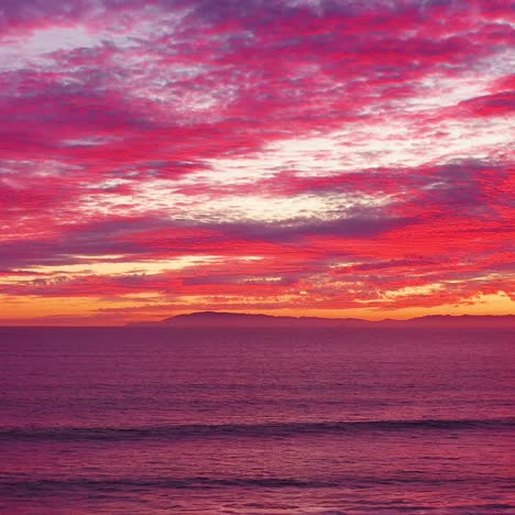 An-astonishing-sunset-aerial-shot-over-a-long-pier-and-the-Pacific-Ocean-and-Channel-Islands-in-Ventura-Southern-California-2