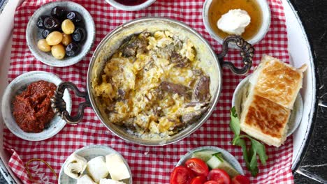 turkish breakfast with eggs, bread, cheese, olives, tomatoes, cucumber, and turkish delight