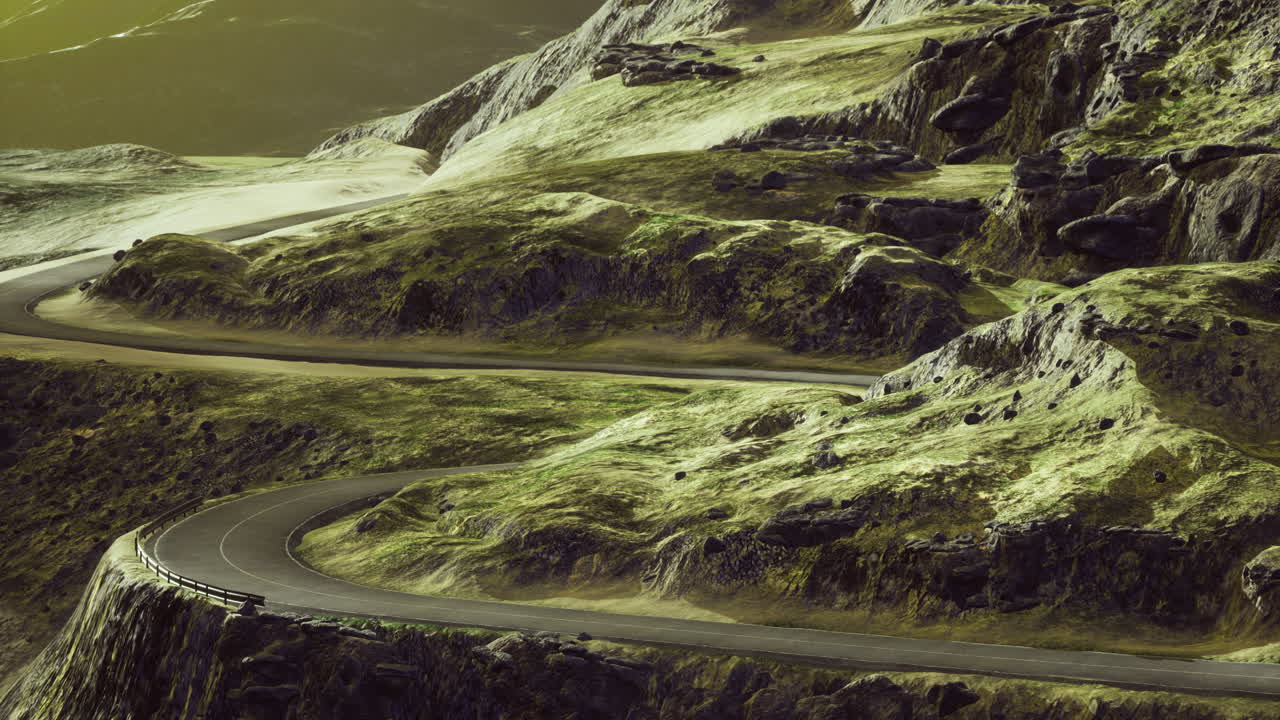 Winding road through green mountains under a golden sky at dusk