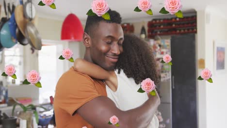 Animation-of-roses-over-african-american-father-hugging-his-daughter