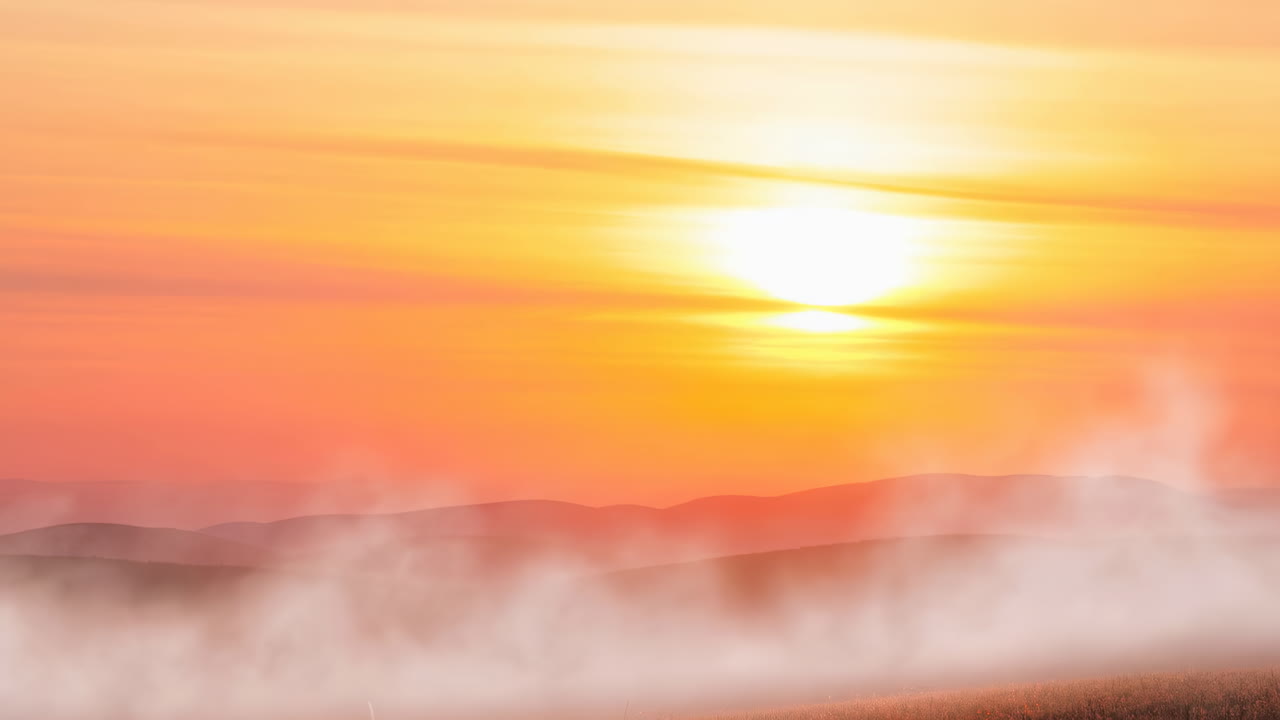 Vibrant Sunset Over Misty Mountain Landscape