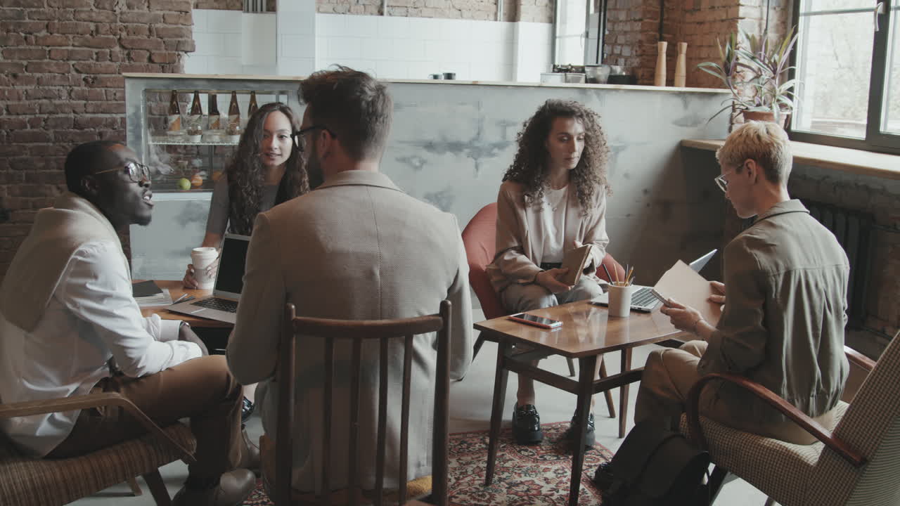Giovani professionisti che parlano in uno spazio di coworking in un loft