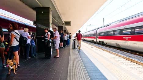 people waiting to board a train in turin