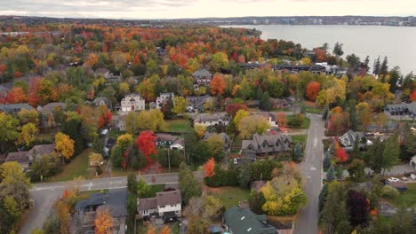 iconic town hiding in autumn color tree landscape, aerial drone view
