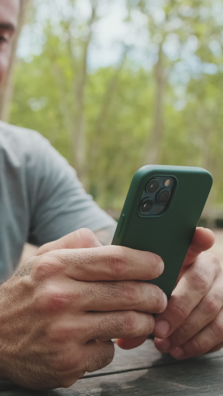 Close-up of Man's Hands Using Smartphone Outdoors