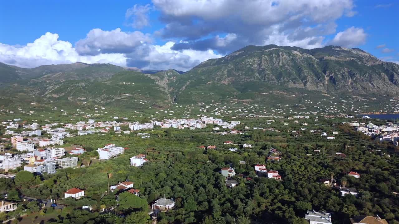 Aerial view of Taygetos mountain covered with clouds, right pan revealing the Messinian gulf and sea of Kalamata on an autumn day 4K