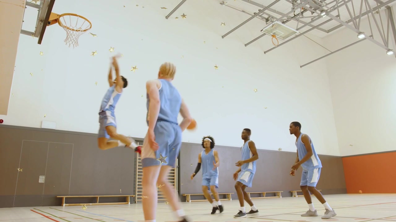 Five male basketball players running offense in gym, left passing to right cutter driving to score
