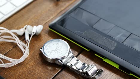 graphics tablet and wristwatch on a table