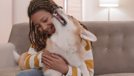 girl having fun with corgi dog