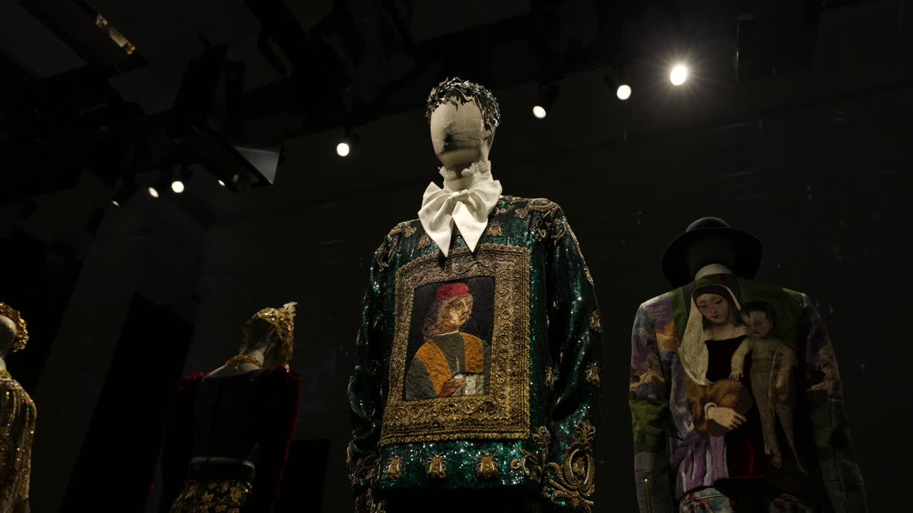 Mannequins displaying artistic garments in a museum exhibit