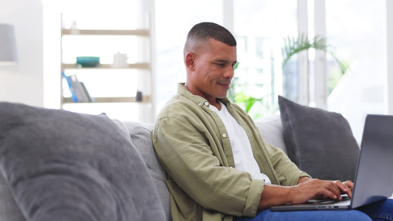 Man, computer and typing on couch for remote work