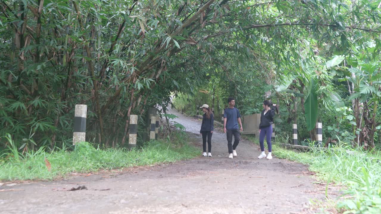 Group of people walking through a forest