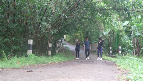 group of people walking through a forest