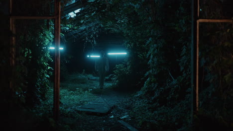 abandoned greenhouse at night - hazmat suit