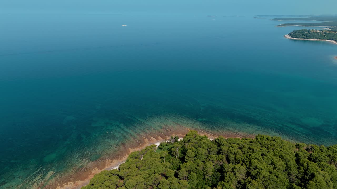 Istria coastline near Pula and Brijuni National Park in Croatia with clear blue sea and lush green trees