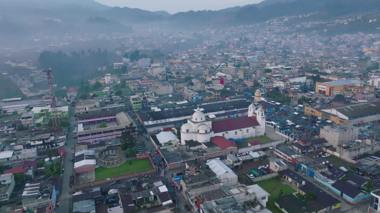 Fast aerial rotation around the central cathedral in San Juan Ostuncalco, Guatemala
