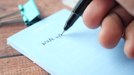 person writing a to-do list