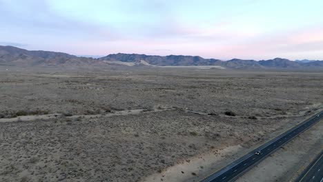 highway 93 in arizona with desert landscape and mountains in the distance with drone video moving up
