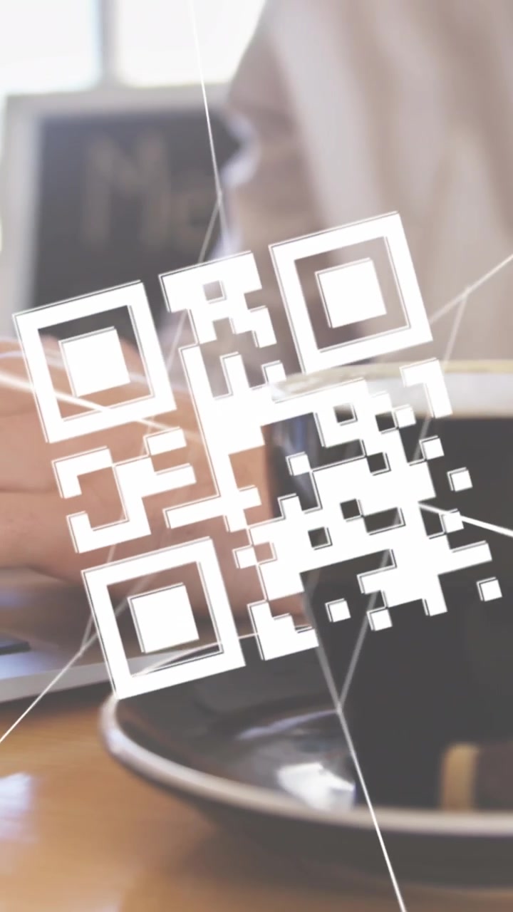Vertical video: IT man typing, thin lines sparking 3D QR over cup, landing near keys, pairing phone
