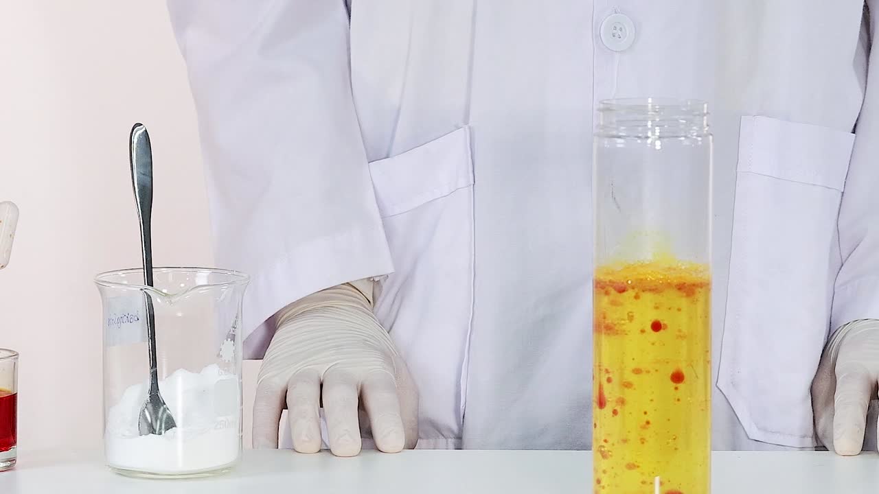 A scientist in a lab coat mixes substances in beakers, observing reactions.