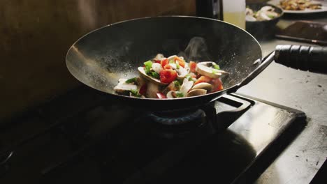 chef adding vegetables on the pan