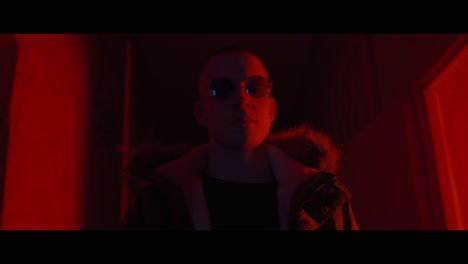 man in a red lit room