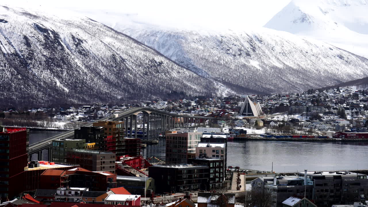 Snow-Covered Mountains And Buildings With The Iconic Arctic Cathedral In Tromso, Norway. Wide Shot