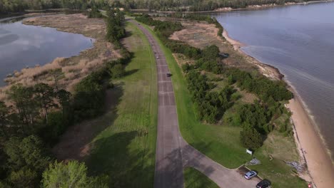 Excellent-Aerial-View-Of-A-Car-Driving-The-Highway-Along-James-River-In-Virginia