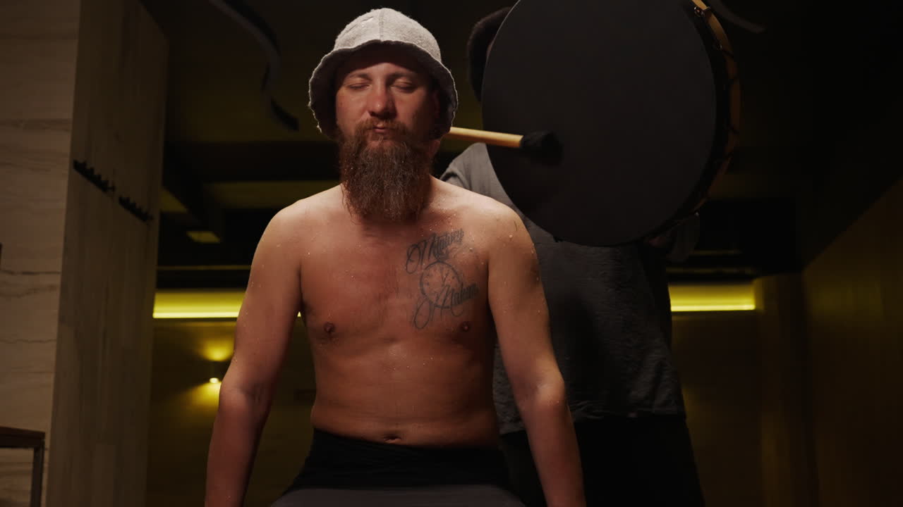 Man receiving drumming therapy session