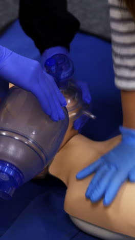cardiopulmonary reanimation. training course of giving first aid on a dummy. medical demonstration on a mannequin doll. vertical video