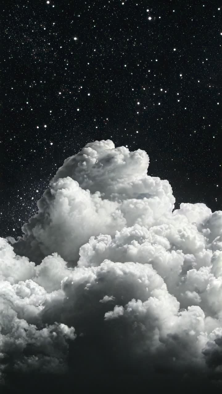 A dramatic upward angle captures fluffy clouds against a starry night sky, creating a surreal