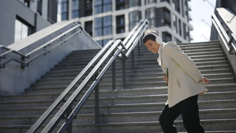 woman dancing on stairs in city
