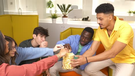 coworkers sharing popcorn during office break