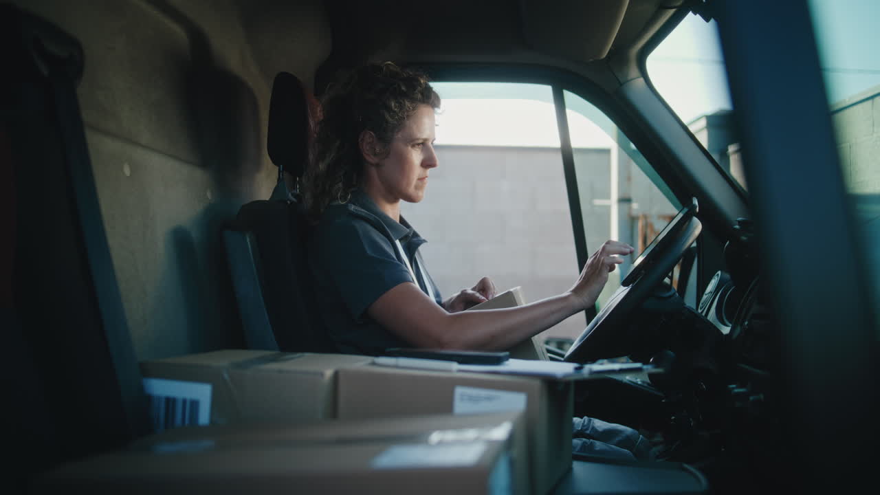 Female Courier Working in a Delivery Van