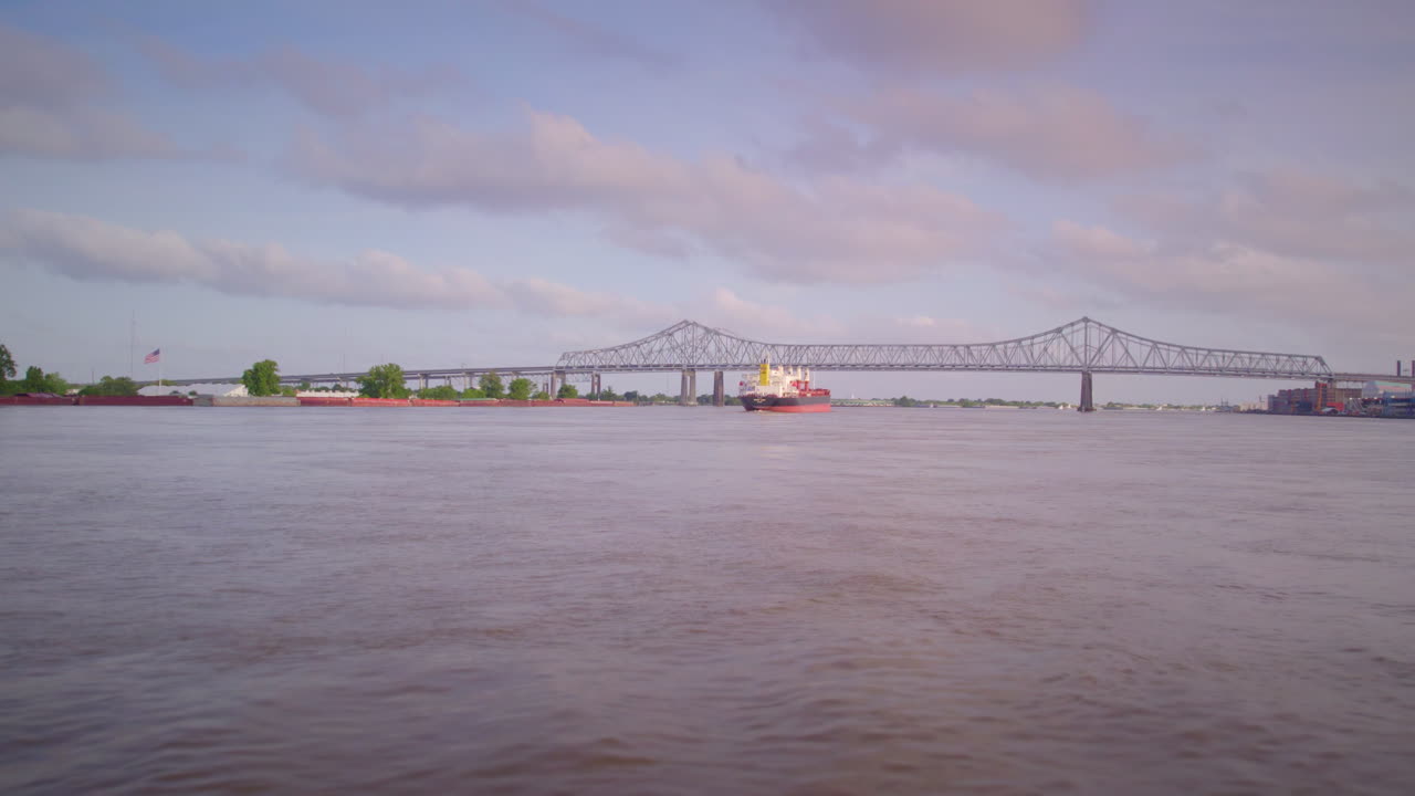 Drone across water towards tanker ship on the Mississippi River