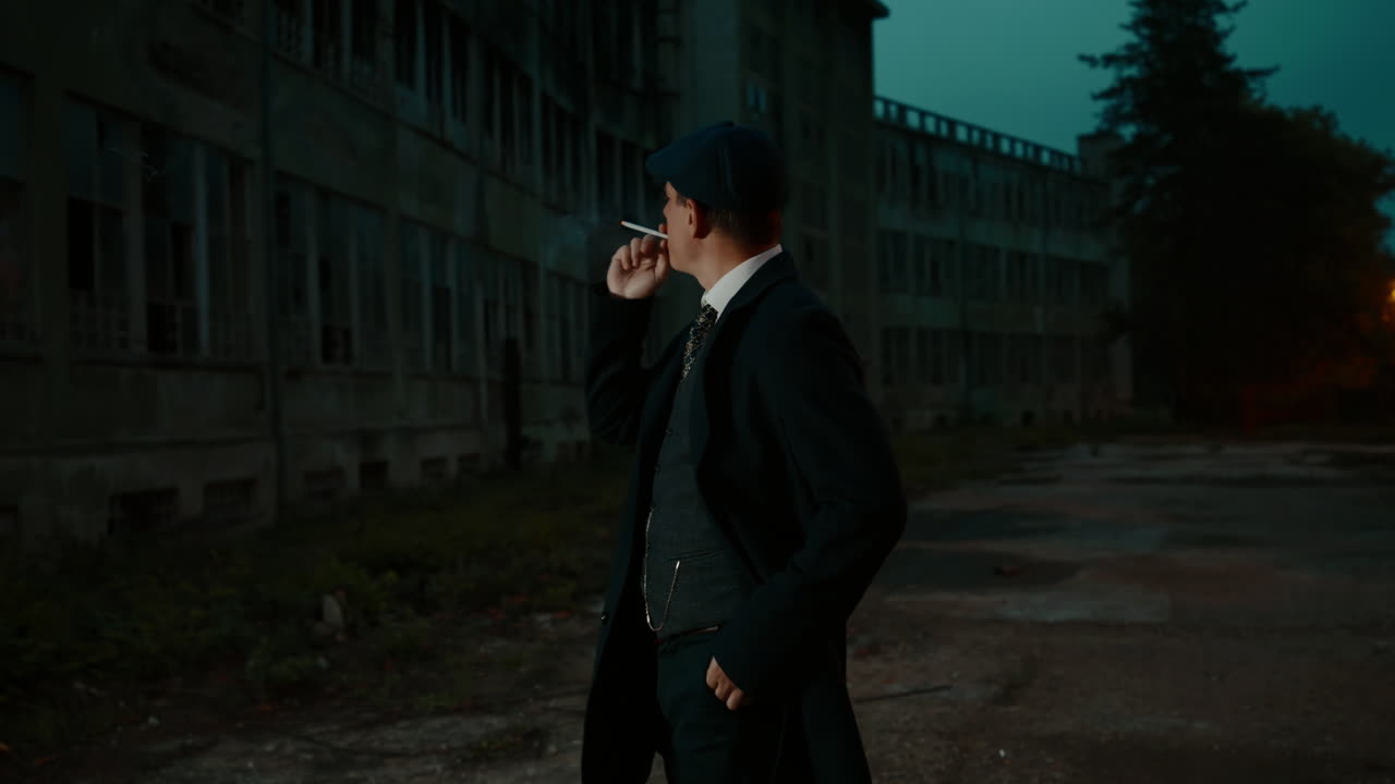 A man in suit in front of an abandoned building