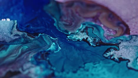 vivid close-up of blue and pink ink diffusing in water, creating an abstract fluid art